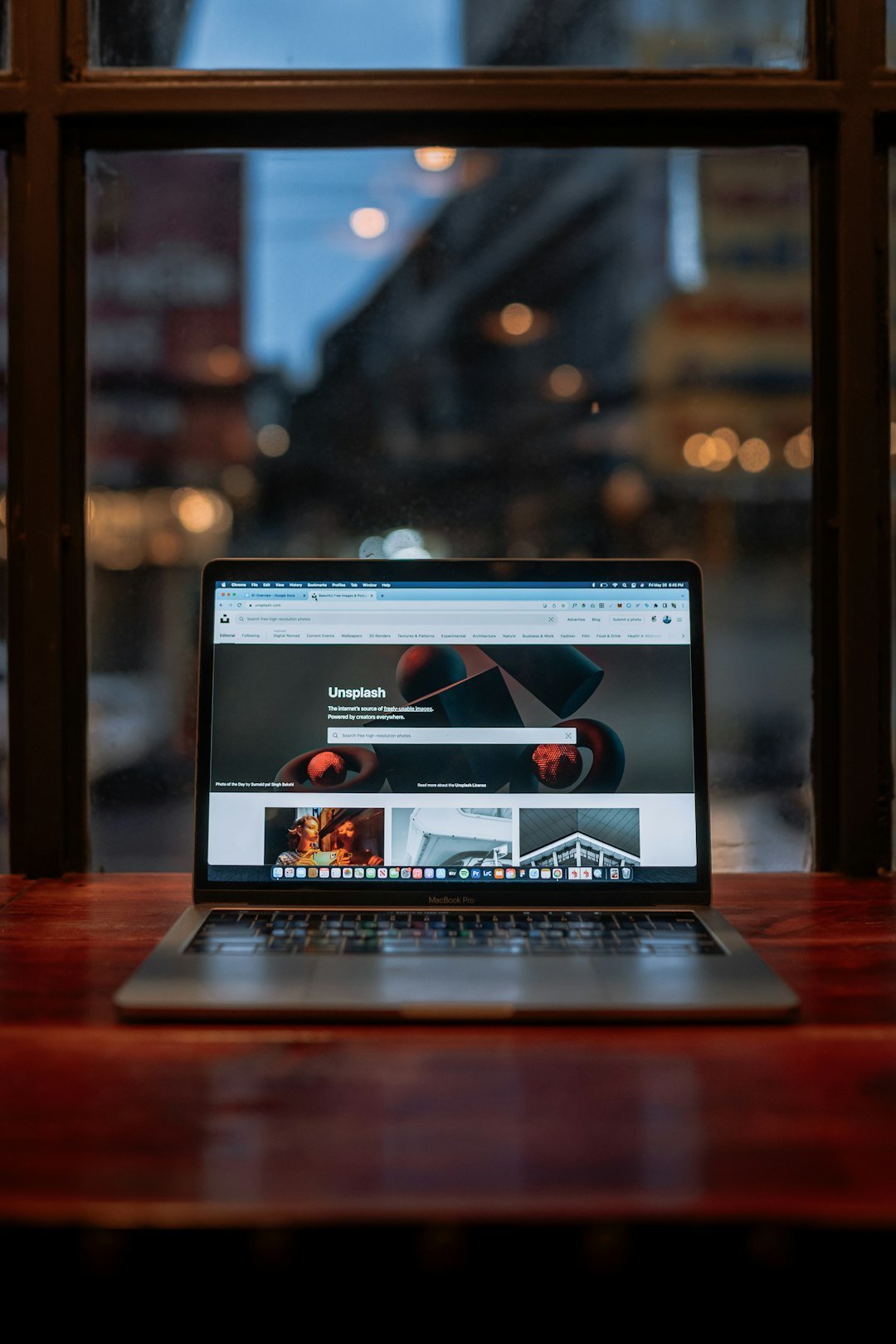 a-laptop-computer-sitting-on-top-of-a-wooden-table-bjjxbdwehdu
